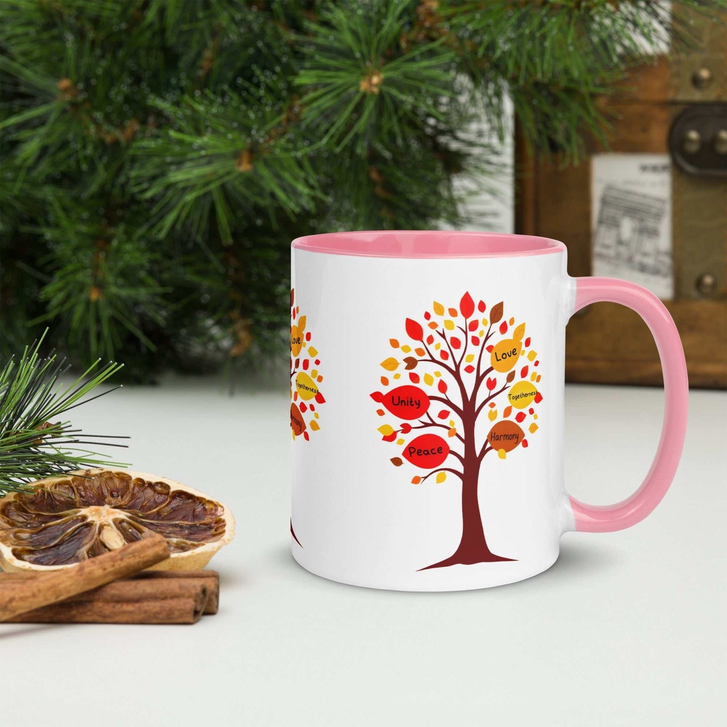 Thanksgiving Tree of Gifts mug with fall-colored tree design and words like love, unity, and harmony; pink interior and handle; perfect for autumn.