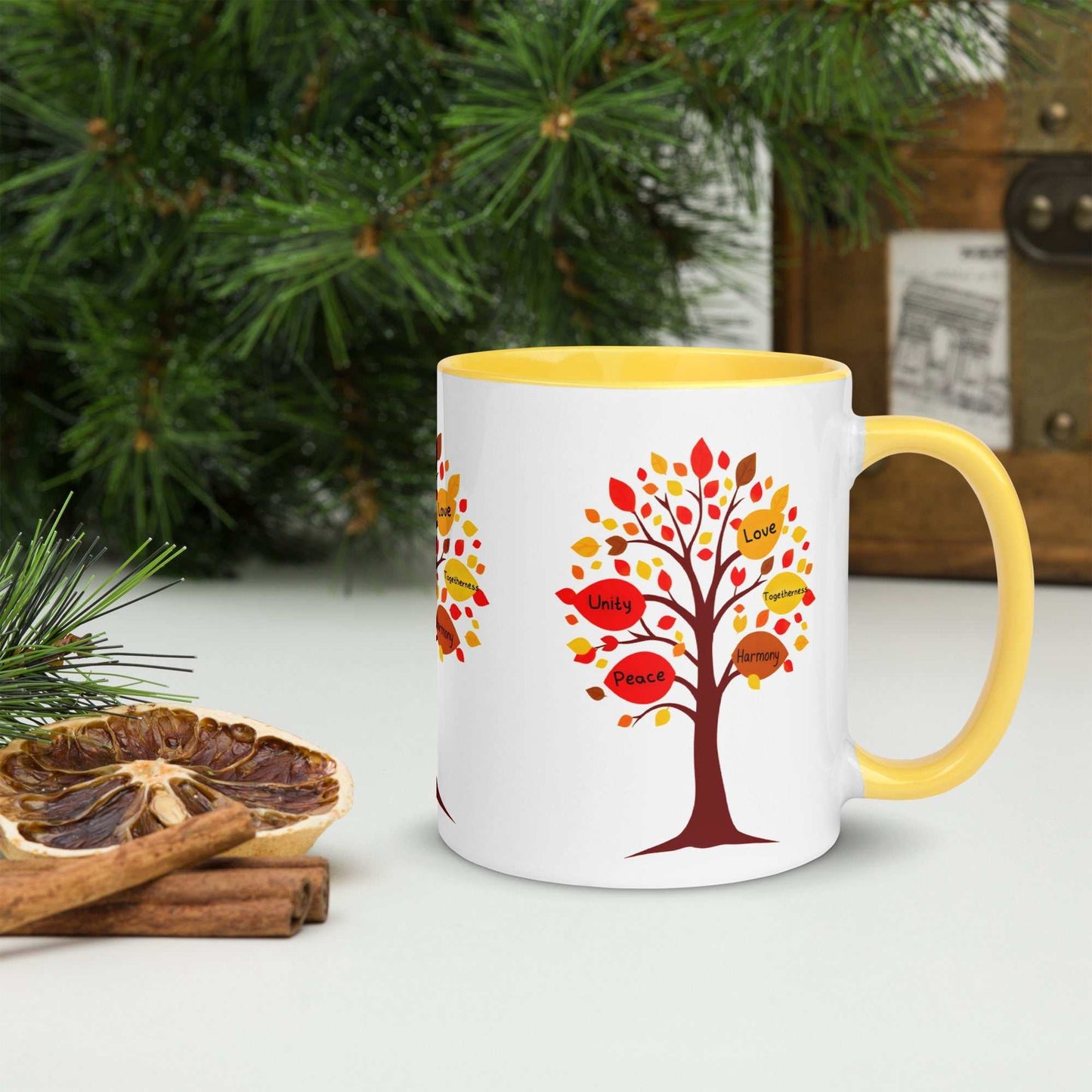 Thanksgiving Tree of Gifts mug with fall-colored leaves featuring messages of love and unity, yellow inside.